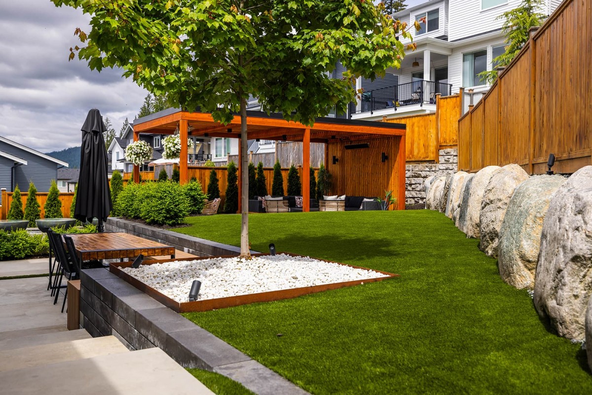 The landscape is designed to be low-maintenance, with minimal upkeep required for the artificial turf and periodic cleaning of the water feature, which supports local wildlife.